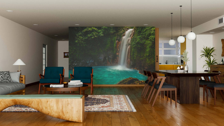 Modern open-plan living and dining area with wooden floors, mid-century furniture, and a Rio Celeste Waterfall Wall Mural. Pendant lights over the dining table and natural light create a cozy, inviting vibe.