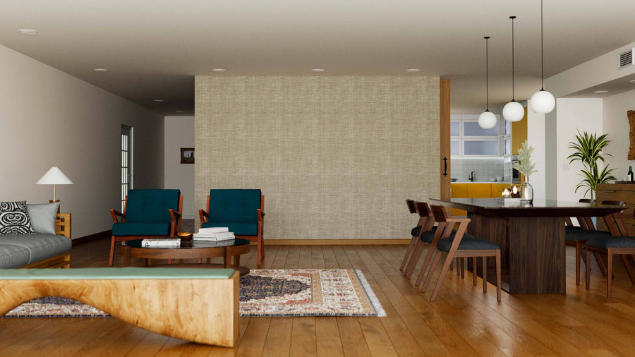 A modern living-dining room features wooden floors, a round coffee table, green armchairs, a gray sofa, and a wood dining table for six. A Rustic Weave Wall Mural creates a textured accent wall separating the kitchen in the background.