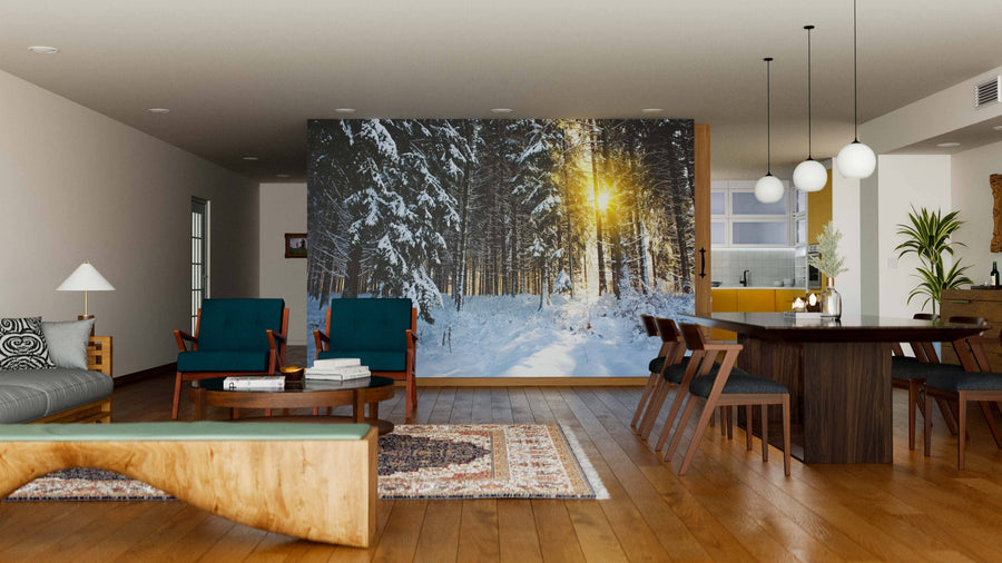 A modern living-dining room with wood floors, mid-century furniture, and a large Sunlight in the Winter Forest Wall Mural. The space includes a sofa, armchairs, dining table, pendant lights, rugs, and an open kitchen.