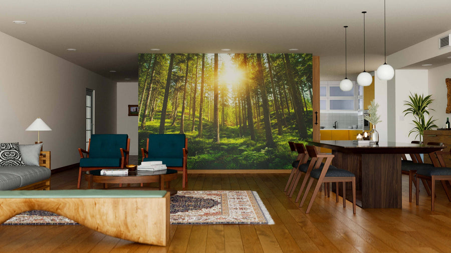 A modern living and dining room with wooden floors, green armchairs, the Sunny Forest Hills Wall Mural on one wall, a dining table with chairs, pendant lights, and an open kitchen. The space feels open and airy.