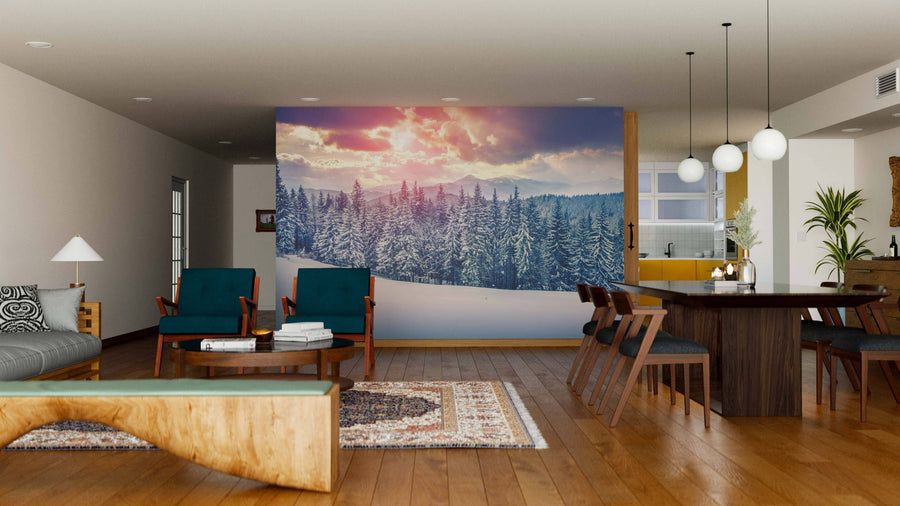 Modern open-plan living and dining room with wood floors, green armchairs, abundant natural light, a pendant-lit dining table, kitchen in the background, and a Sunrise in the Carpathian Mountains Wall Mural creating a stunning focal point.