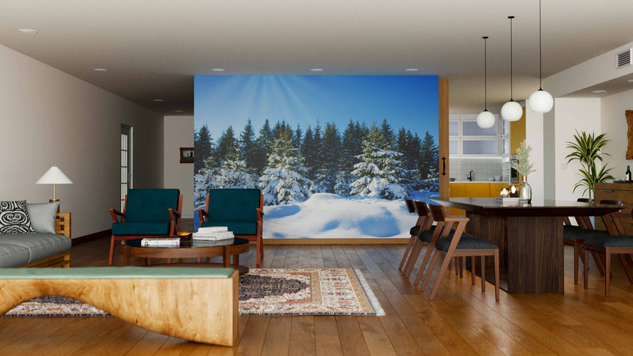 A modern living-dining area with wood floors, stylish furniture, and globe pendant lights features the Sunset in the Winter Forest Wall Mural, adding charm and a wintry landscape to this open, cozy space filled with natural and artificial light.