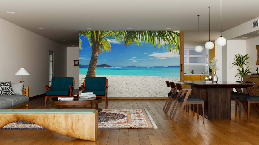 Modern living and dining room with wooden floors and furniture. The Tree on White Sand Beach Wall Mural creates an open, relaxing vibe. Pendant lights hang above the dining table; the kitchen can be seen in the background.