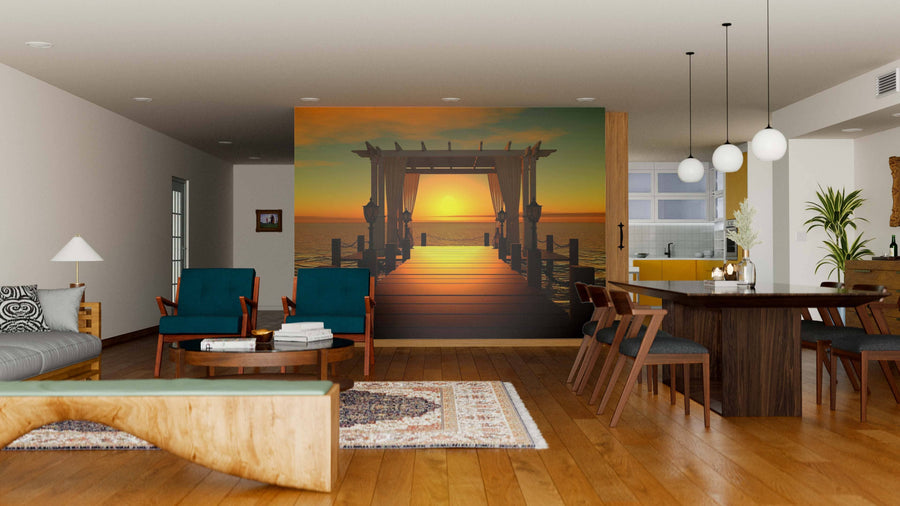 A modern living and dining room with wooden floors, dark dining furniture, teal armchairs, a curved wooden coffee table, and the "Wedding Gazebo on the Pier Wall Mural" creates a warm and inviting atmosphere.