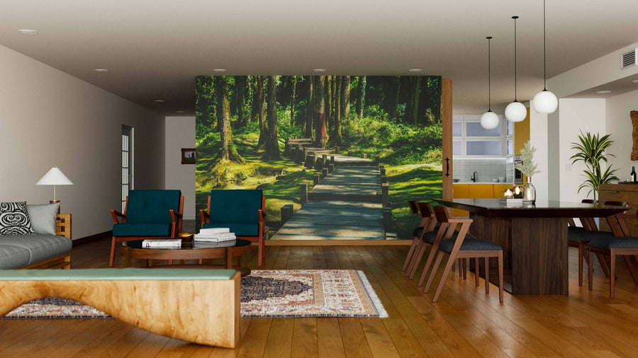 A modern living-dining area features wooden floors, teal armchairs, a long dining table, pendant lights, and the Wooden Walkway in the Forest Wall Mural for a serene, natural accent to the contemporary décor.