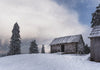 An empty house on a snowy mountain hill