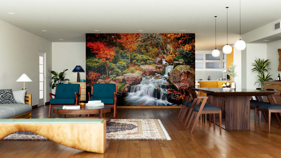 A modern open living-dining room with wood floors, teal chairs, and a wooden dining table is enhanced by the Lush Japanese Waterfall Wall Mural, adding vibrant color and natural beauty to the cozy, neutral décor.