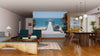 A modern living and dining room with wood floors and mid-century furniture features the Manhattan Beach Pier Wall Mural, a peel-and-stick decor option that frames a stunning ocean view for easy, stylish ambiance.