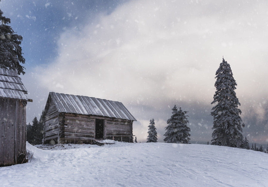 An empty house on a snowy mountain hill