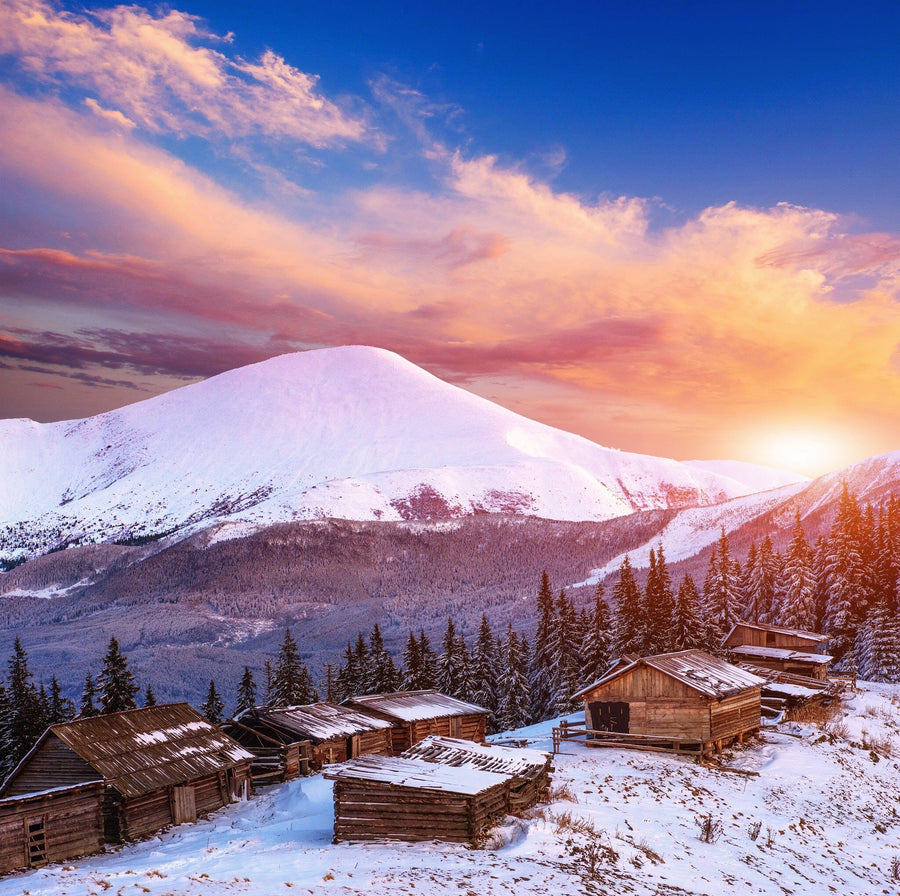 Scenic view of a mountain cottage at sunset with colorful sky