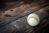 Baseball with red stitching on rustic wood – Peel and Stick Wall Murals