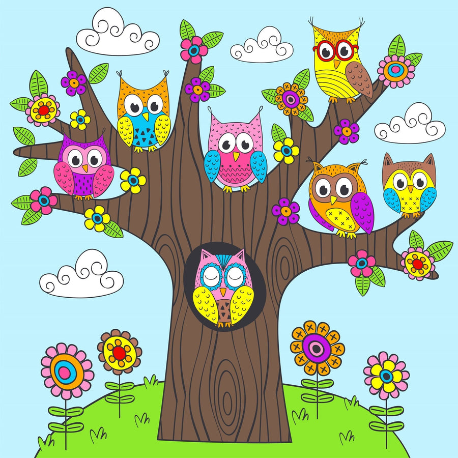 The Nursery 4 Wall Mural showcases a tree with nine vibrantly patterned owls perched on its branches, surrounded by flowers and grassy patches. Puffy clouds drift across a blue sky, creating a playful and whimsical scene ideal for custom printed or peel-and-stick wall murals.