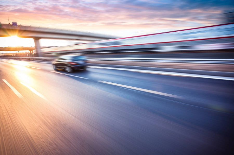 Car Driving on Freeway at Sunset Wall Mural