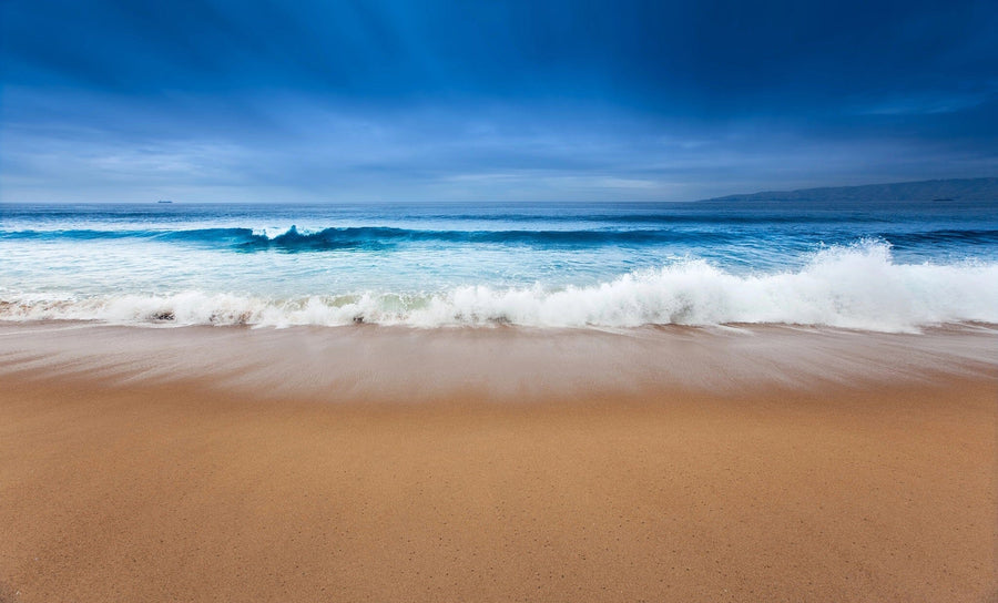 Sandy beach with gentle waves under a clear blue sky – Peel and Stick Wall Murals