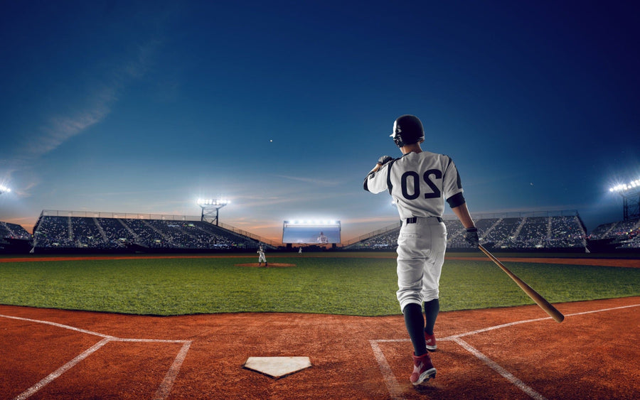 A baseball player in a white uniform with number 20 stands ready to bat under sunset stadium skies. The Home Run Wall Mural brings this thrilling scene to your space, capturing the game's excitement in a stunning peel and stick design.