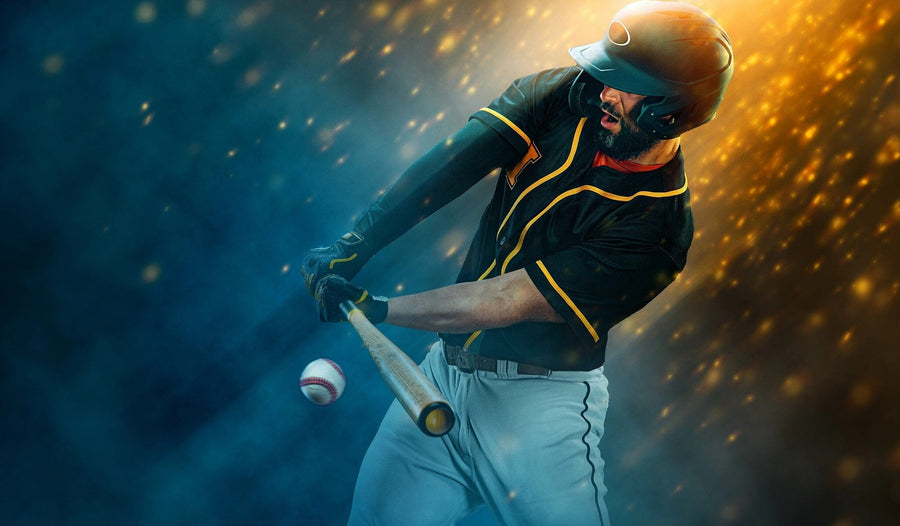A baseball player in black and yellow gear swings at a pitch amid golden lights and blue smoke—captured in the Baseball 10 Wall Mural, a peel and stick decor piece that brings exciting action to any room.