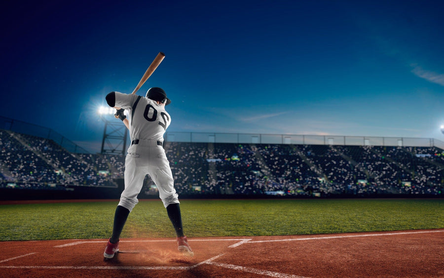Bring the thrill of the game to your space with the Ready to Swing Wall Mural, capturing a player ready to bat under bright stadium lights—perfect for sports fans seeking dynamic, canvas-textured wall art.