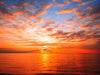 Breathtaking sunset at the sea with fluffy clouds painted across the sky – Peel and Stick Wall Murals