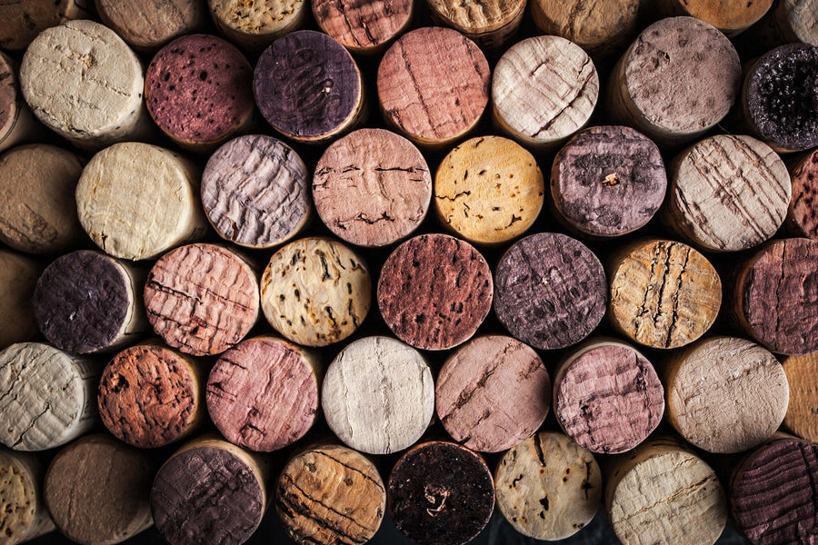 A close-up of the Wine Corks Wall Mural by displays horizontally arranged corks in natural colors from light beige to dark brown and reddish hues, showcasing textures and grain patterns reminiscent of removable wallpaper designs.