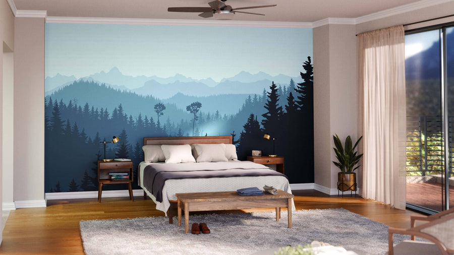 A modern bedroom features a bed, two nightstands, a wooden bench, and a gray rug. The wall showcases the Mist in Forest Hills Wall Mural. Large windows with sheer curtains let sunlight in; minimal decor and plants complete the look.