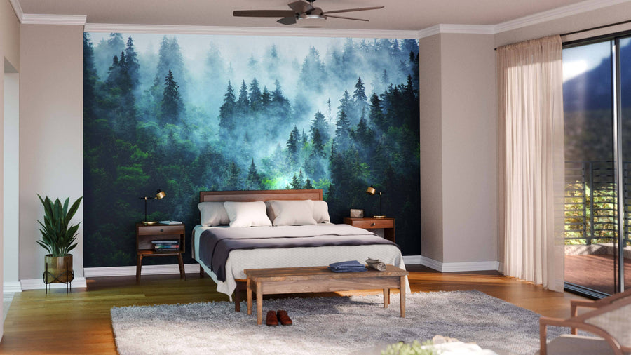 A modern bedroom is anchored by the Misty Mountain Way Wall Mural behind a wooden bed. Neutral walls, nightstands with lamps, a cushioned bench, plant, sheer curtains, and a light gray rug complete this serene space.