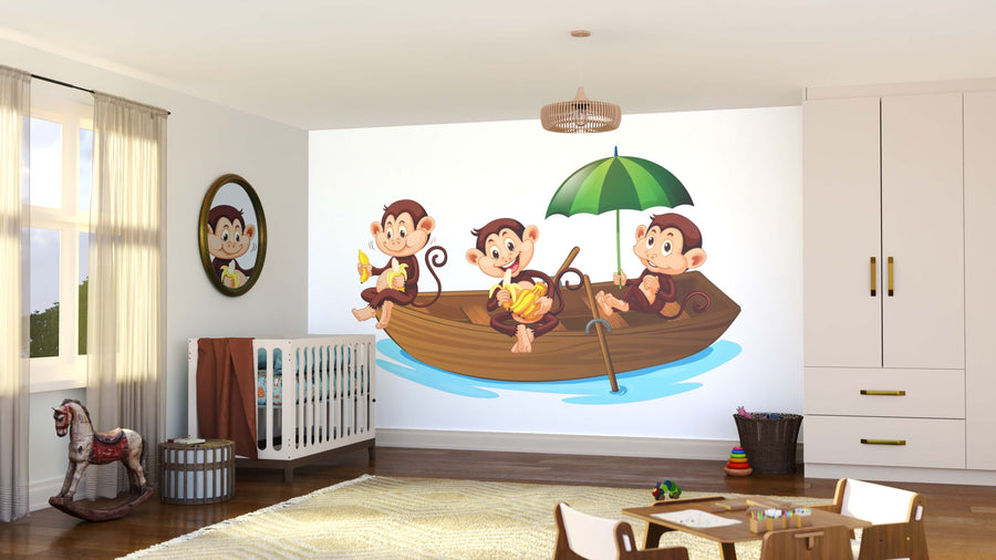 A bright nursery showcases the Monkey Cruise Wall Mural, depicting three cartoon monkeys in a boat under a green umbrella. Nearby are a crib, rocking horse, kids’ furniture, and scattered toys, while a round mirror reflects one monkey’s face.