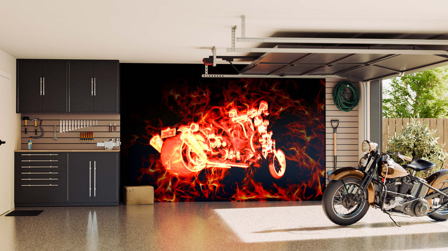 A modern garage with black cabinetry and organized tools features the Fiery Burning Motorbike Wall Mural. A classic bike rests on the glossy floor near a window showcasing lush greenery outside.