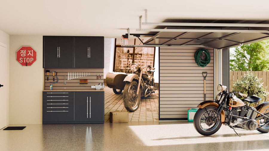 A modern garage with dark cabinets, tools on a pegboard, a Korean stop sign, and a Retro Motorcycle Wall Mural. A wall-mounted hose, garden tools, and sunlight streaming through an open door reveal a green yard outside.