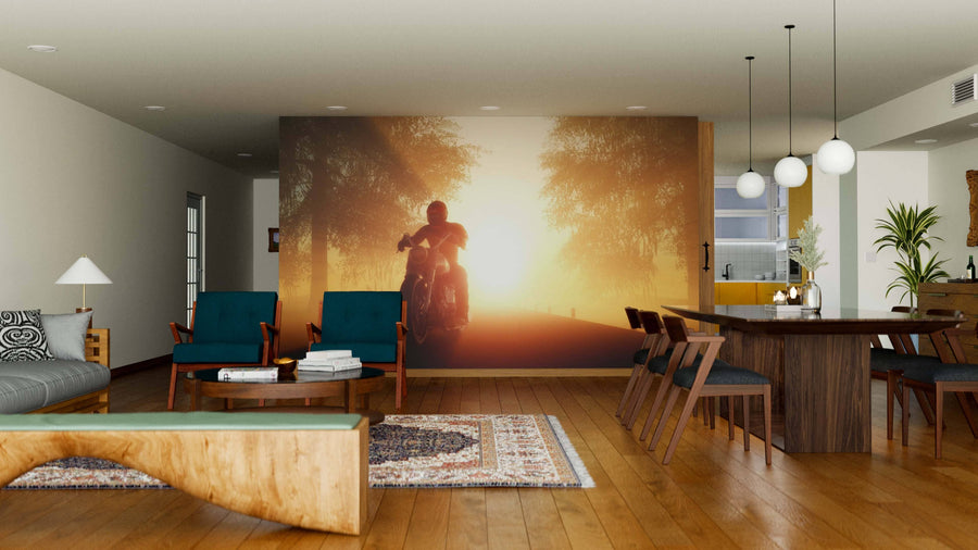 A modern living-dining room with wooden furniture, teal chairs, rugs, and pendant lights features the Motorcyclist Wall Mural on the back wall, adding a warm, inviting, and adventurous touch to the space.