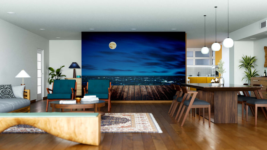 A modern open-concept living and dining area with wood floors and mid-century furniture features the Night Wooden Pier Wall Mural as a dramatic focal point, paired with rugs, pendant lights, plants, and contemporary decor.