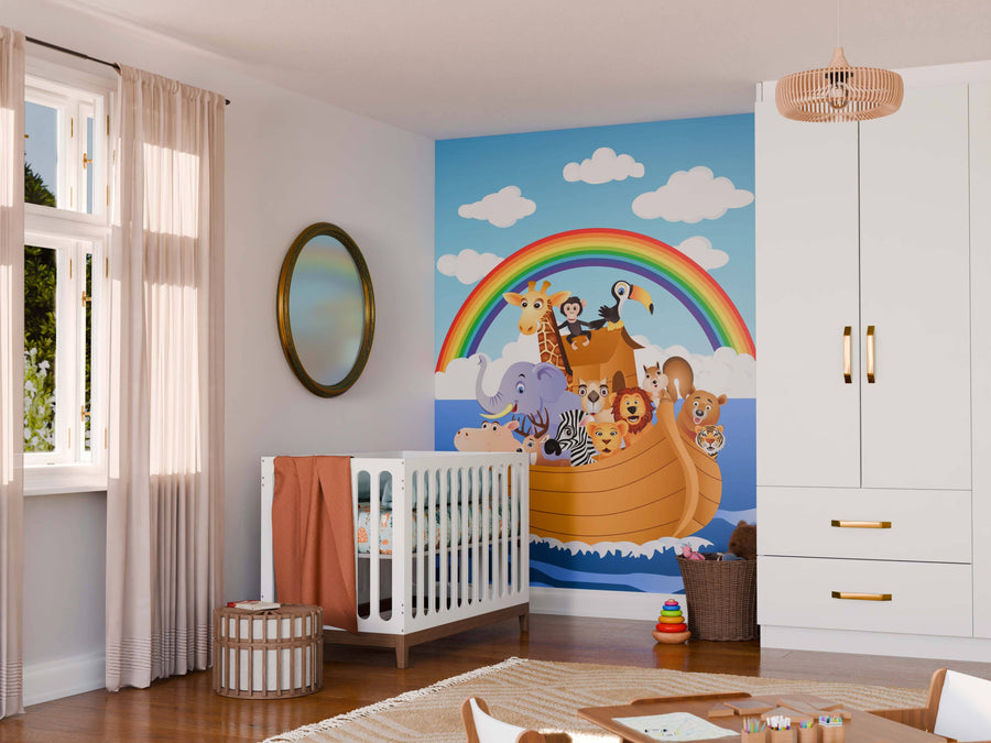 A nursery with a crib, soft decor, and the Animal Cartoons Wall Mural—a large peel and stick mural of cartoon animals on Noah’s Ark beneath a rainbow. The room has neutral walls, beige curtains, soft lighting, and neatly arranged children’s toys.