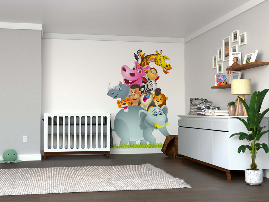 A nursery includes a white crib, dresser, shelves with plush toys and baby essentials. The highlight is the peel and stick Animal Stack Wall Mural showing colorful cartoon jungle animals. A green plant and rug finish the decor.