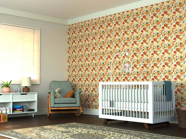 A nursery featuring a white crib, pale blue armchair with a stuffed animal, toy shelf, patterned rug, and sunlight streaming through the window, with an accent wall adorned in the Autumn Fox Wonderland Wall Mural.
