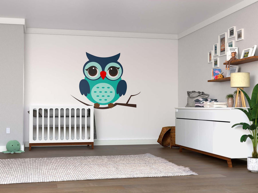 A modern nursery with a white crib, Cute Blue Owl Wall Mural, white dresser, wooden shelves with toys, framed photos, green plant, and a light rug on wood floors. Light gray walls create a tidy and cozy atmosphere.