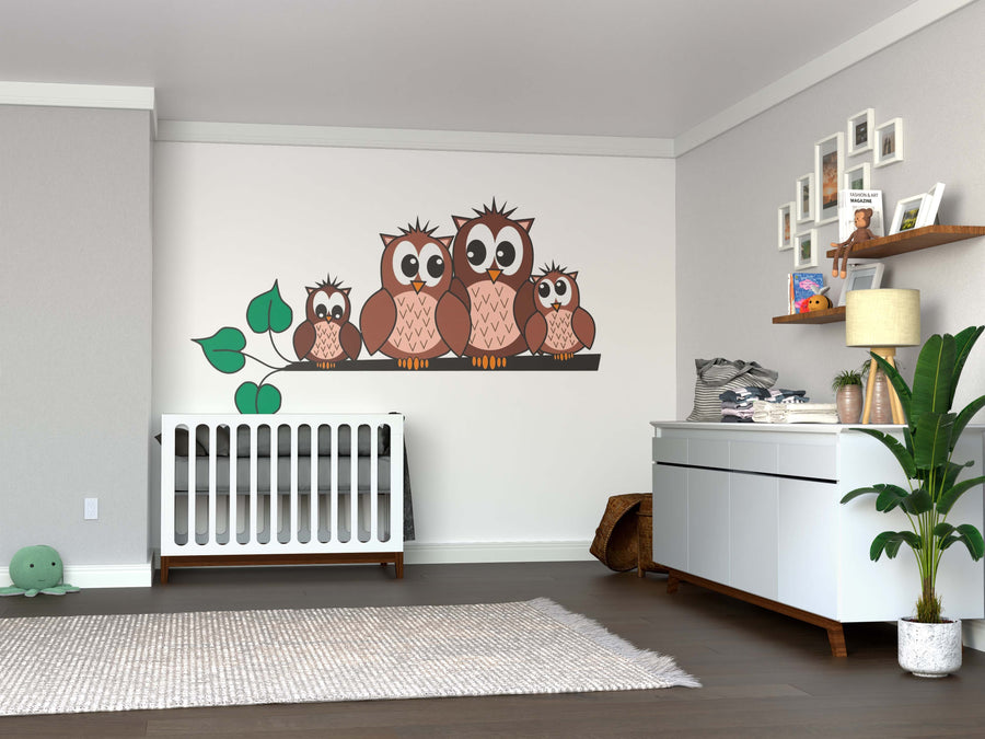 A modern nursery with a white crib, dresser, soft rug, plant, and decorative shelves features the A Cute Owl Family Wall Mural. The bright room has wood floors, neutral walls, is tidy and inviting—perfect for a welcoming space.
