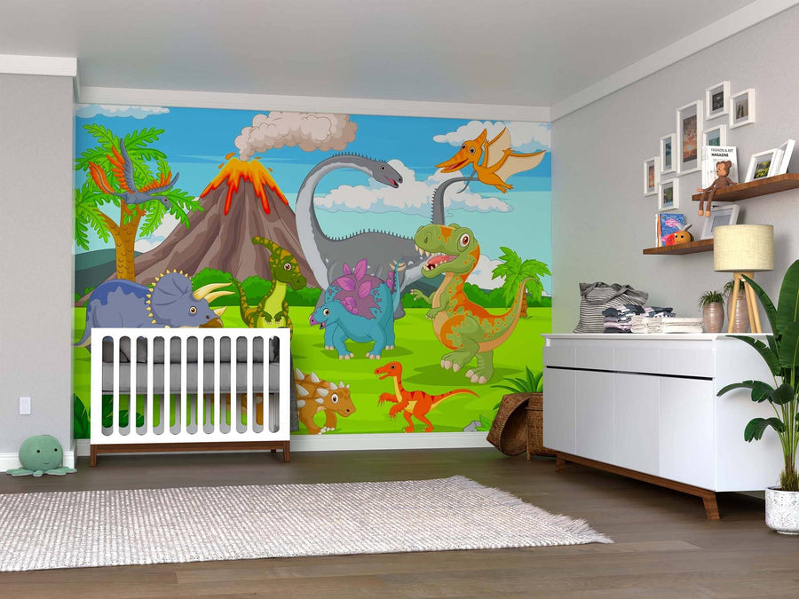 A nursery features the Dino Adventure Wall Mural, a colorful peel and stick design with cartoon dinosaurs, volcanoes, and palm trees under a blue sky, along with a crib, white dresser, plants, and shelves holding toys and books.