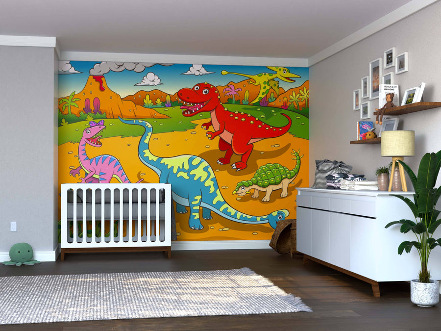 A nursery with a crib, dresser, and plants features the Dino Playground Wall Mural—a vibrant peel and stick design of colorful dinosaurs, including a red T. rex, blue long-neck, pink dino, and green turtle among volcanoes and palm trees.