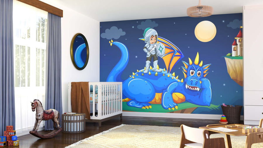 A cozy, sunlit nursery features the Dragon and Knight Wall Mural—a smiling blue dragon with a cheerful child knight under a full moon. A white crib, rocking horse, and soft rug complete this playful setting.
