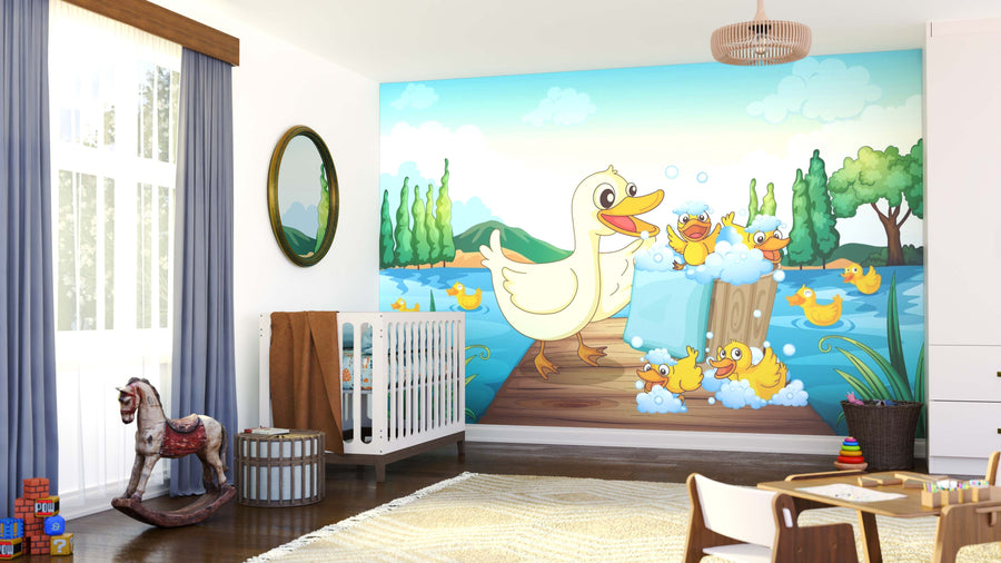 A bright nursery features the Duck Family Wash Wall Mural, showing a large cartoon duck and ducklings splashing in water. The room includes a crib, rocking horse, toys, an oval mirror, and big windows with blue curtains for playful charm.