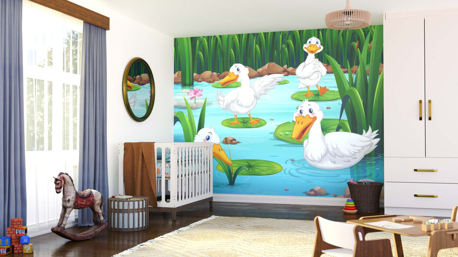 A nursery with a crib, toys, rocking horse, and basket features the Duck Friends Wall Mural—four cartoon ducks on lily pads among green reeds and a pink water lily. Sunlight enters through a window with light blue curtains.