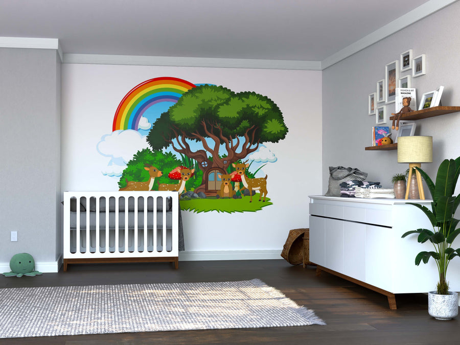 A bright nursery with a white crib, dresser, toys, and plants. The Enchanted Forest Home Wall Mural displays whimsical trees, animals, and a rainbow, adding vibrant color. Wooden shelves above the dresser hold books and decor.