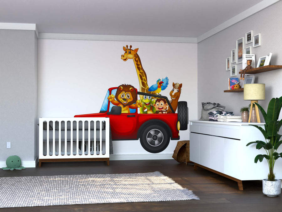A nursery features a white crib and dresser, with the Jeep Safari Fun Wall Mural showing cartoon animals in a red jeep. Wood floors, a plant, and shelves with toys and decor complete this playful space.