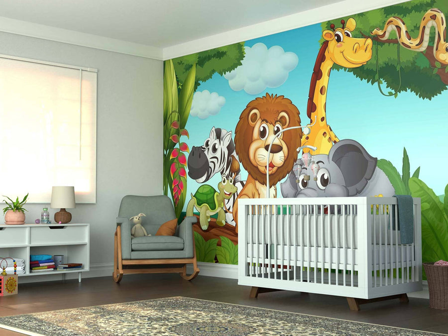 A nursery with a gray armchair, white crib, and shelf features the Jungle Family Wall Mural—a peel and stick mural of cartoon jungle animals (giraffe, lion, zebra, monkey, elephant, snake) with greenery under a blue sky.