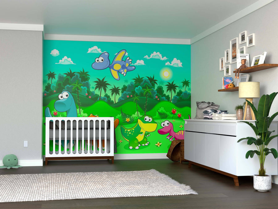 A nursery with a crib, dresser, wooden floors, and shelves for books and baby supplies. The wall displays the Jungle Jamboree Wall Mural—colorful cartoon dinosaurs, trees, flowers, and a bright sun. A green plush turtle toy adds a playful touch.
