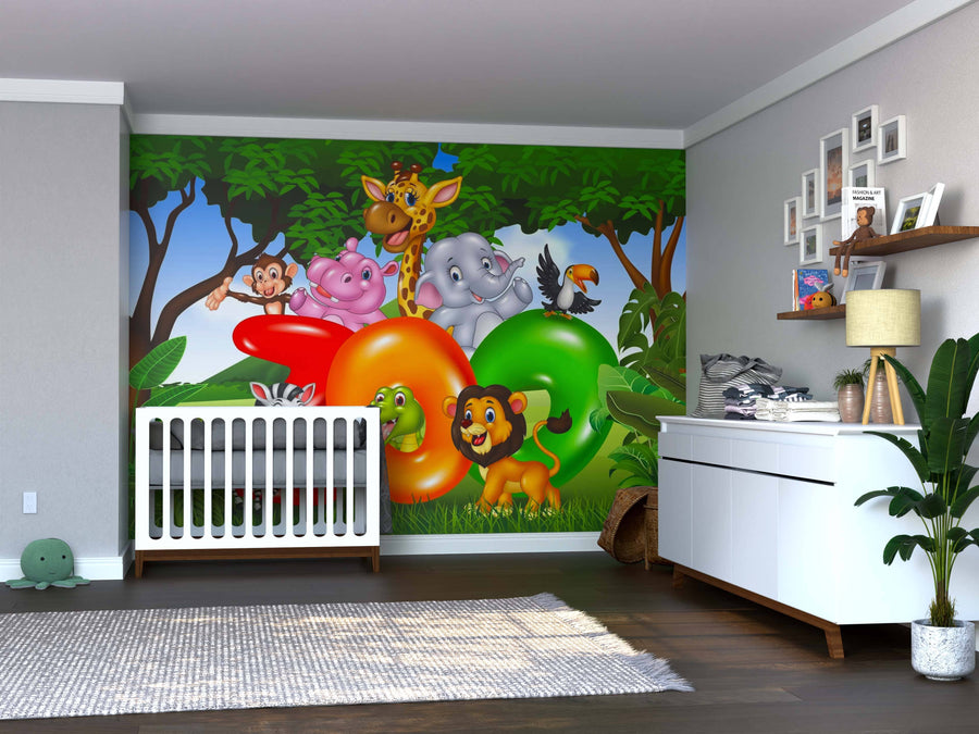 A nursery room with a white crib, dresser, and green plants. The wall features the colorful Jungle Zoo Party Wall Mural with smiling cartoon animals among trees. Toys and baby items are arranged on the dresser and shelf.