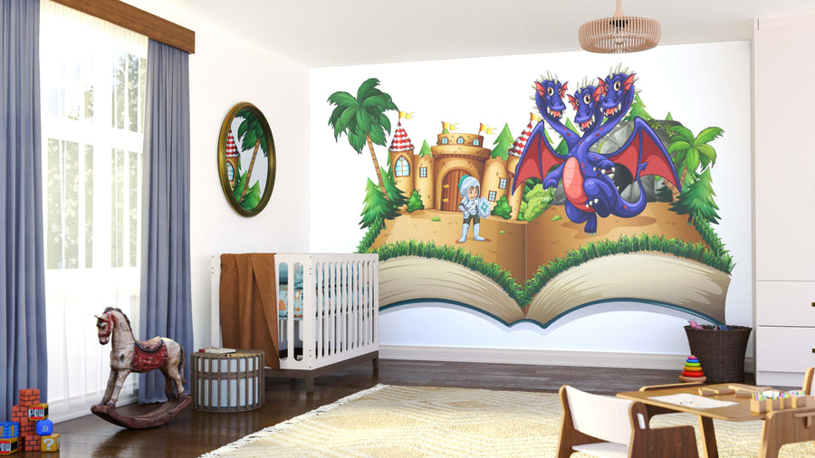 A nursery with the Knight vs Hydra Wall Mural showing a knight, three-headed dragon, castle, palm trees, and rainbow. The room also has a crib, rocking horse, round mirror, basket, toys, and large windows with blue curtains.