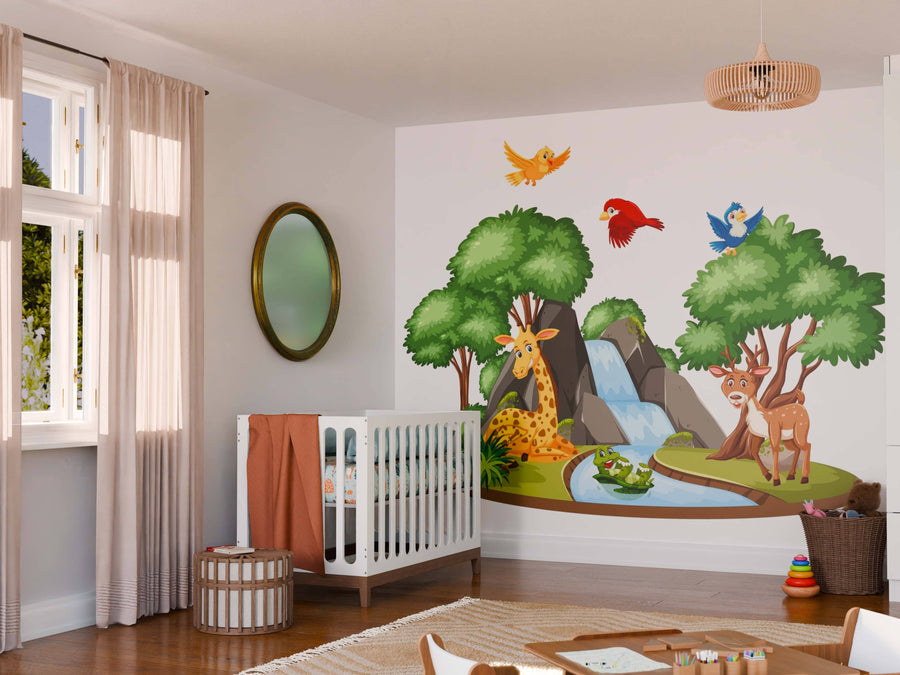 A nursery features a white crib, soft furnishings, and the Lush Green Wildlife Wall Mural—removable wallpaper with cartoon giraffe, deer, and birds. Natural light fills the space. A round mirror hangs beside the mural.