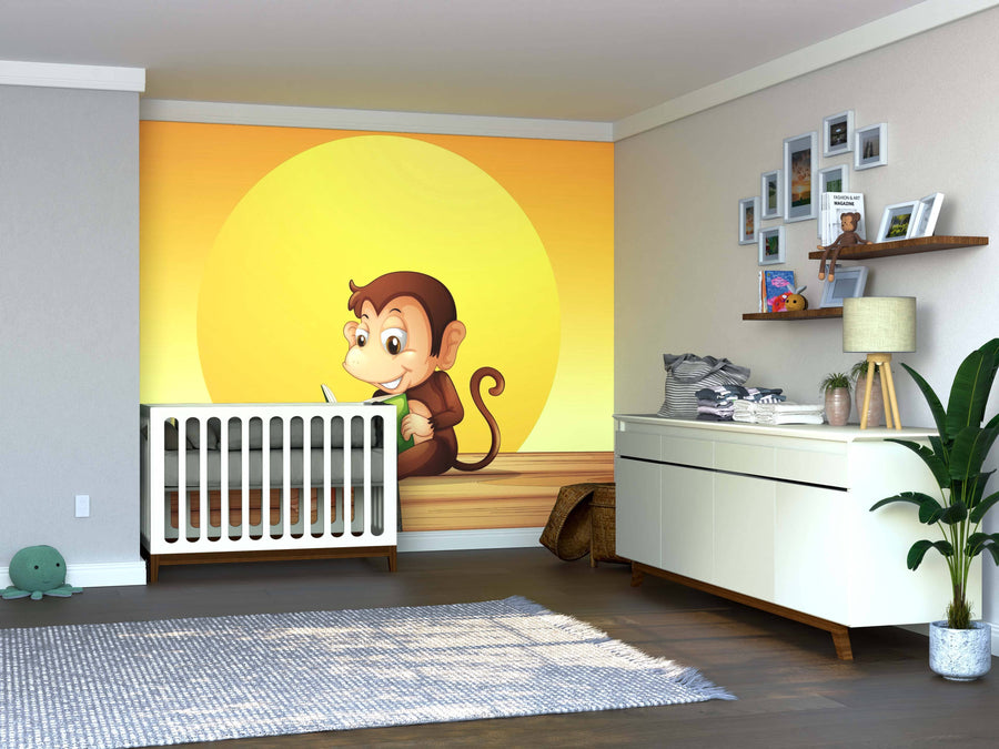 A nursery with a crib in front of the Monkey Reading Wall Mural showing a smiling cartoon monkey and yellow sun, plus a white dresser, potted plant, wall shelves with decor, framed photos, and a soft toy turtle on the floor.