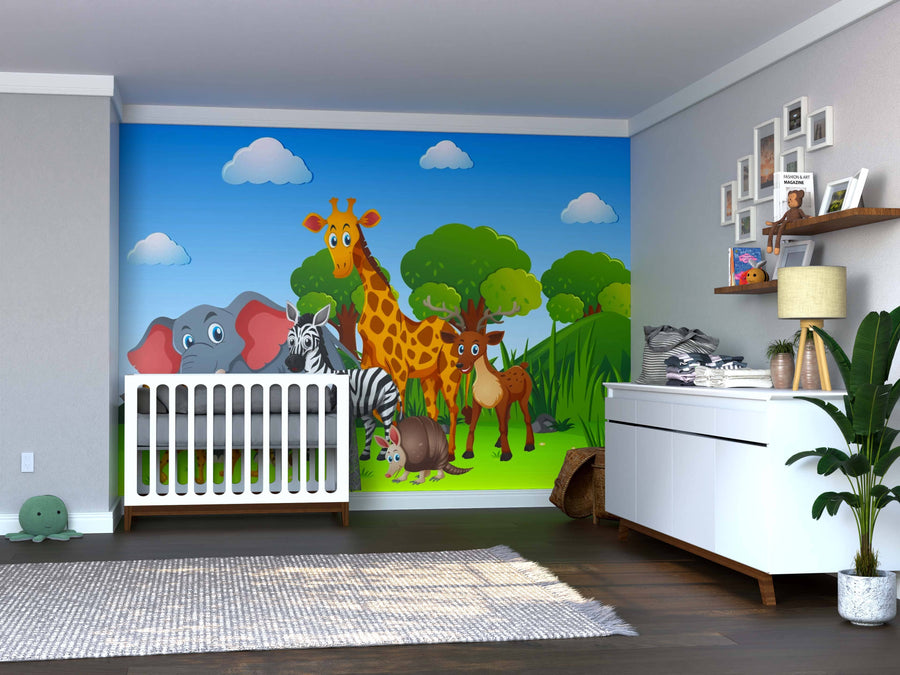 A nursery features a white crib and dresser, a potted plant, baby supplies, framed photos, and the Nature’s Wild Companions Wall Mural with cartoon jungle animals—giraffe, elephant, zebra, lion, antelope—set against a bright blue sky.