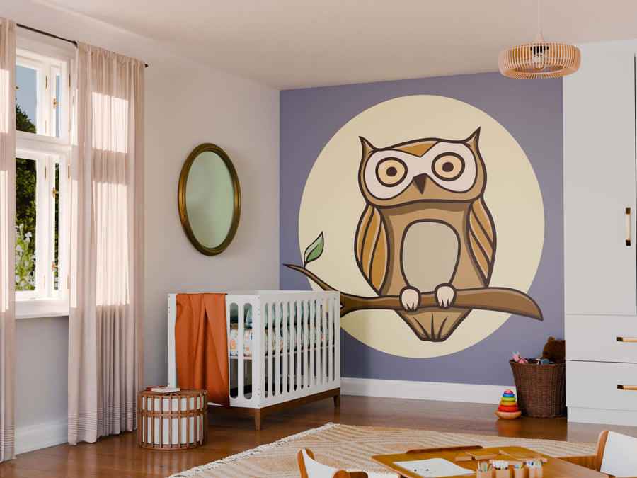 A cozy nursery with wooden floors features the Owl Doodle Wall Mural, showing a cartoon owl on a branch. The room includes a white crib with orange bedding, wicker decor, a round mirror, toy baskets, and sunlight through sheer curtains.